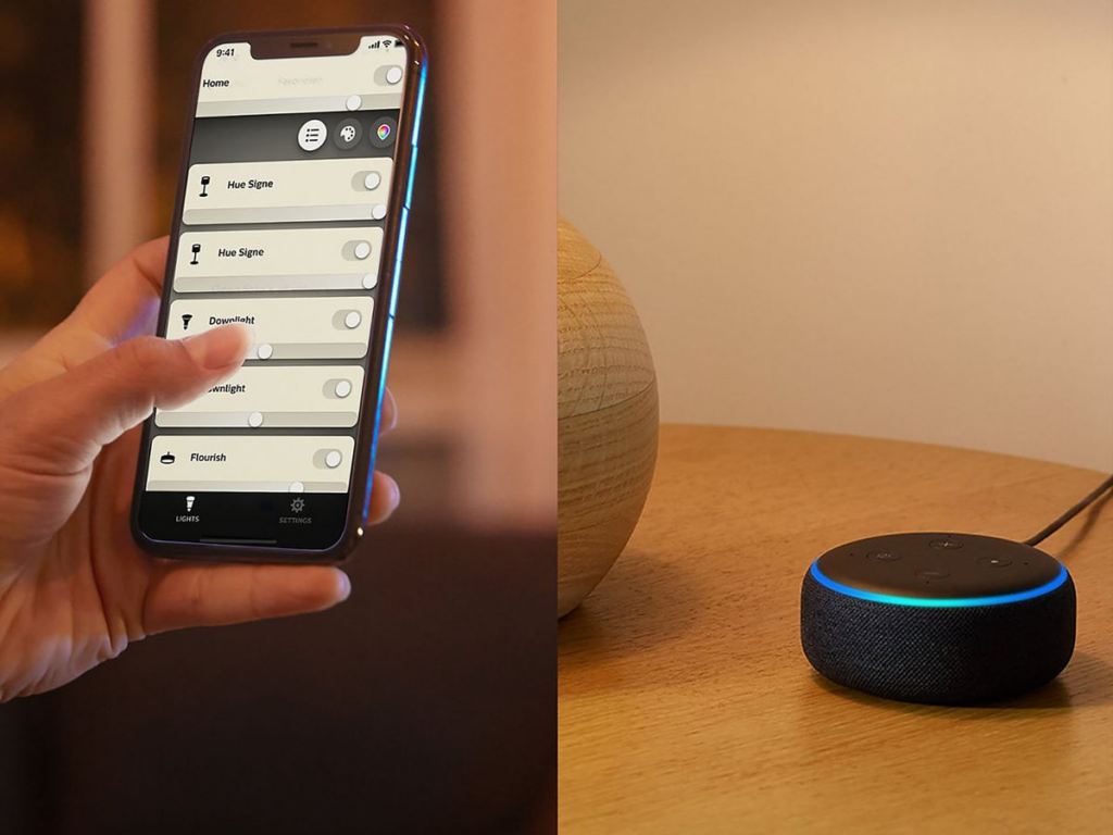 Hand holding smartphone and setting up smart speaker