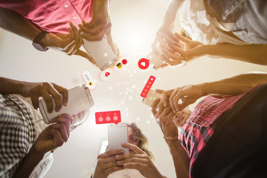 People using smartphones for social media interaction, shot from below