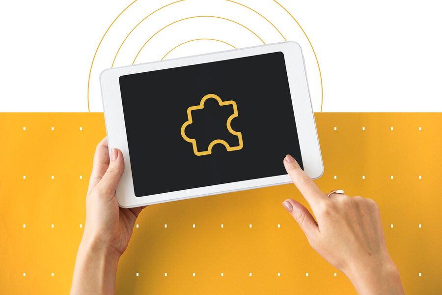 Hand holding a tablet with a browser extension icon
